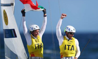 The Italian sailing team celebrates after their gold medal race