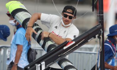 Erik Heil of Team Germany packs up his boat after sailing competition is postponed