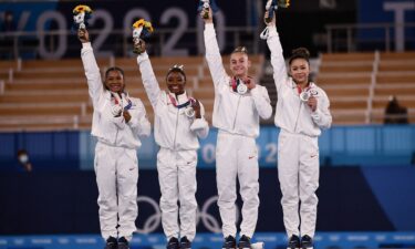 Team USA's gymnastics team celebrate silver in the all-around competition