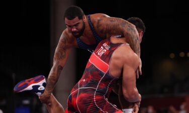 An upright Gable Steveson has one arm around the nck of Turkey's Taha Akgul and a hand on his opponent's ankle