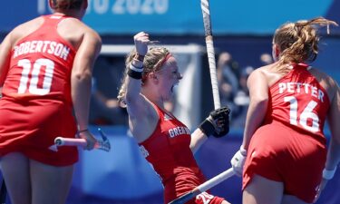 Hollie Pearne-Webb of Team GB raises her first in celebration with Sarah Robertson and Isabelle Petter