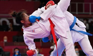 China's Gong Li takes a kick to the face from Switzerland's Elena Quirici