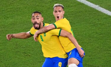 Matheus Cunha pumps his fist and celebrates with Antony after Brazil's opening goal