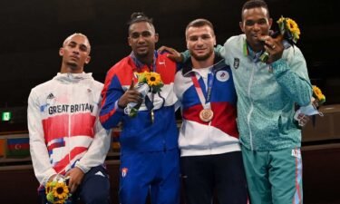 A sullen Benjamin Whittaker refuses to wear his silver medal next to gold medalist Arlen Lopez of Cuba and bronze medalists Imam Khataev of the ROC and Loren Berto Alfonso Dominguez of Azerbaijan.