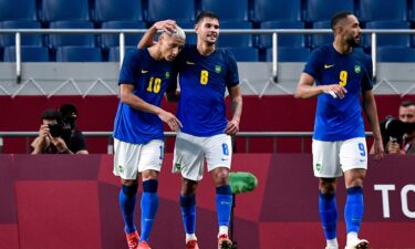 Neymar and Richarlison celebrate in a match against Saudi Arabia.