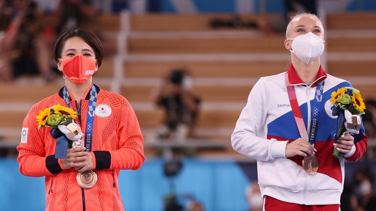 Mai Murakami of Team Japan and Angelina Melnikova of Team ROC look on during the Women's Floor Exercise Final on day ten of the Tokyo 2020 Olympic Games