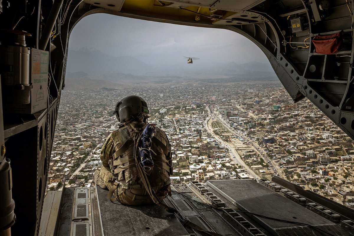 An American soldier sits on a CH-47 Chinook helicopter flying over Kabul on May 2.