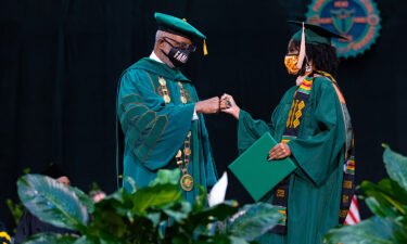 FAMU President Larry Robinson greets a 2020 graduate during the July 31 ceremony.