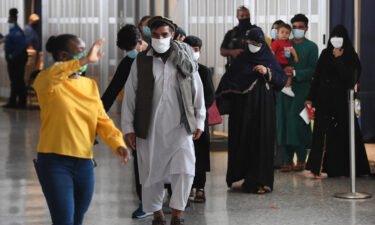 Afghan refugees arrive at Dulles International Airport on August 27 in Dulles