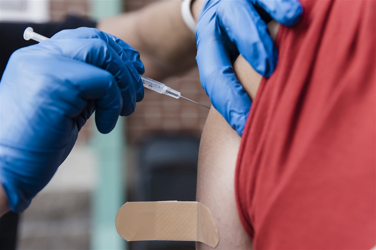 A healthcare worker administers a dose of the Pfizer-BioNTech Covid-19 vaccine at a pop up vaccination site in Missouri on August 3.