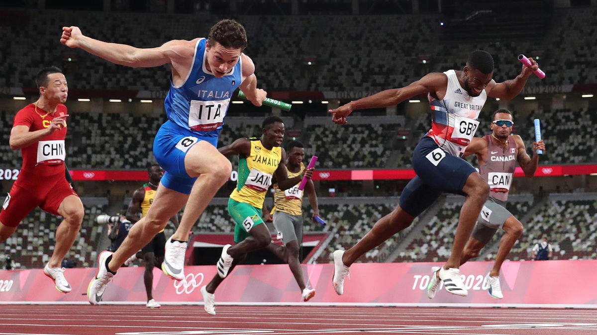 Filippo Tortu of Team Italy beats Nethaneel Mitchell-Blake of Team Great Britain across the finish line to win the gold medal in the Men's 4 x 100m Relay Final on day fourteen of the Tokyo 2020 Olympic Games