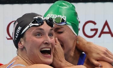 Tatjana Schoenmaker of Team South Africa celebrates with Annie Lazor of United States after winning the gold medal and breaking the world record after competing in the Women's 200m Breaststroke Final on day seven of the Tokyo 2020 Olympic Games
