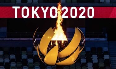 The opening ceremony's torch shines brightly in Tokyo.