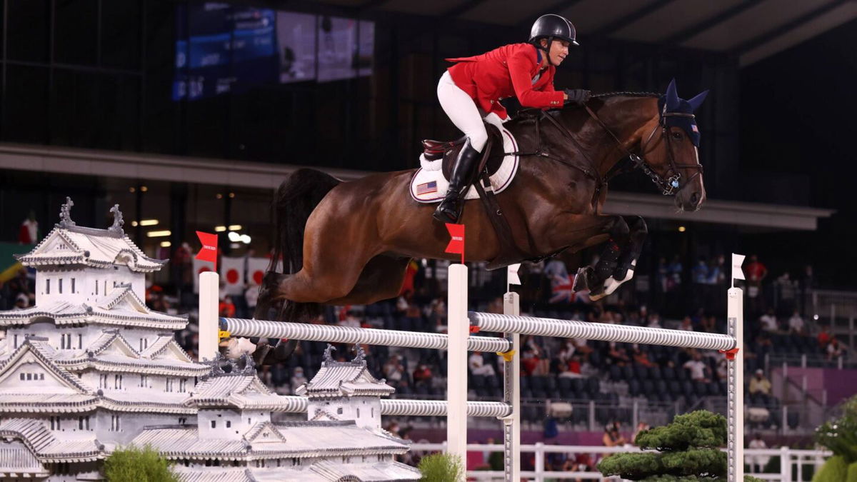 Laura Kraut and Baloutinue go over a white jump with tiny white pagodas on the sides