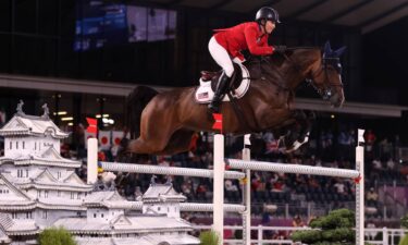 Laura Kraut and Baloutinue go over a white jump with tiny white pagodas on the sides