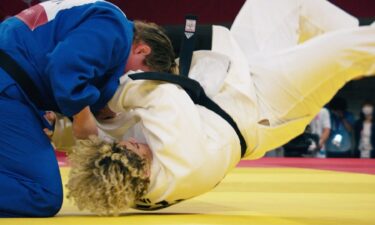 Two Olympians in the judo tournament hit the mat after a takedown