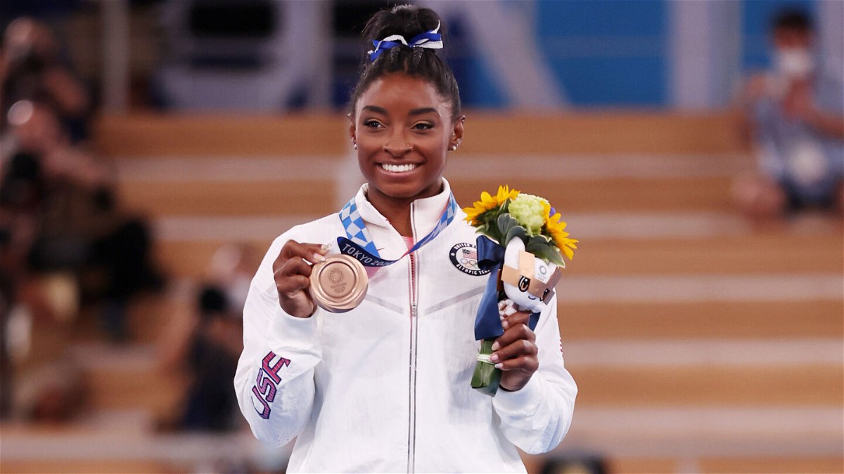 <i>Jamie Squire/Getty Images</i><br/>Biles poses with the bronze medal at Ariake Gymnastics Centre