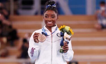 Biles poses with the bronze medal at Ariake Gymnastics Centre