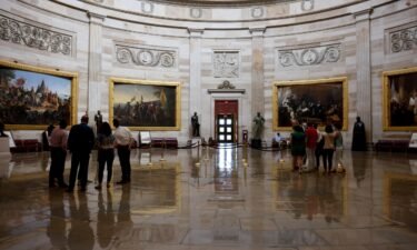 Staff members and interns admire the rotunda of the U.S. Capitol Building on August 6 in Washington.