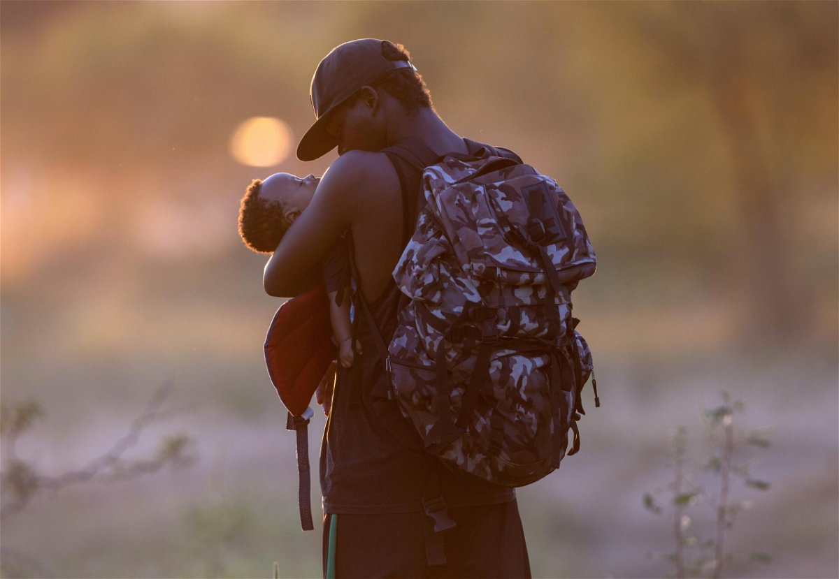 <i>John Moore/Getty Images</i><br/>An exhausted Haitian father cradles his son on the Mexican side of the Rio Grande from Del Rio