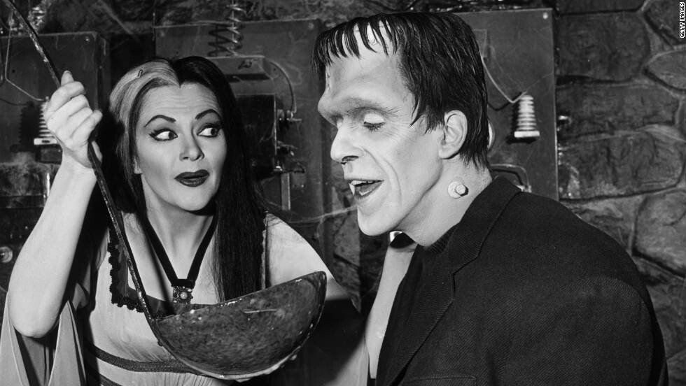 <i>Getty Images</i><br/>Lily Munster (Yvonne De Carlo) holds a giant ladle for Herman Munster (Fred Gwynne) in an episode of the original 