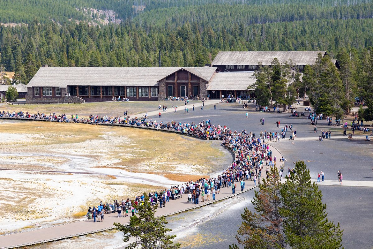 <i>Jacob W. Frank/NPS</i><br/>Crowds gather for an afternoon Old Faithful geyser eruption in September 2021.