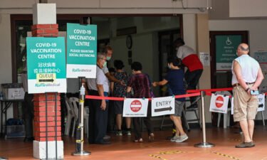 People enter a Covid-19 vaccination center in Singapore on October 7.