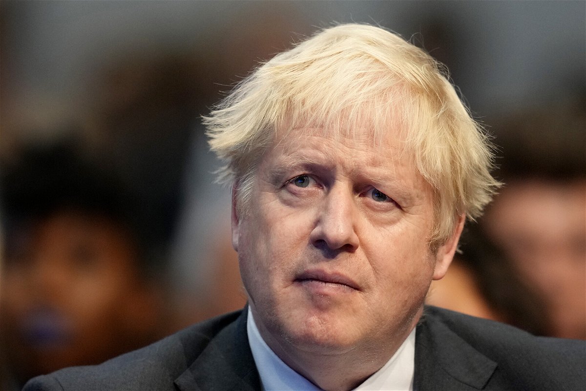 <i>Christopher Furlong/Getty Images</i><br/>British Prime Minister Boris Johnson listens to Chancellor of the Exchequer Rishi Sunak giving a speech at the Conservative party's conference in Manchester on October 4
