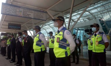 Indonesia's Bali and Riau Islands are reopening to visitors from 19 countries starting Thursday. Airport security personnel are shown here during a briefing in preparation of the reopening of International Ngurah Rai Airport in Bali