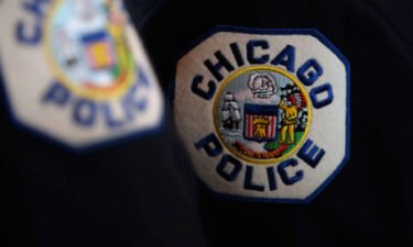 Up to half of Chicago's rank-and-file police officers could be placed on unpaid leave starting Friday because of a dispute between their union and Mayor Lori Lightfoot over a city requirement for officers to disclose their vaccine status.