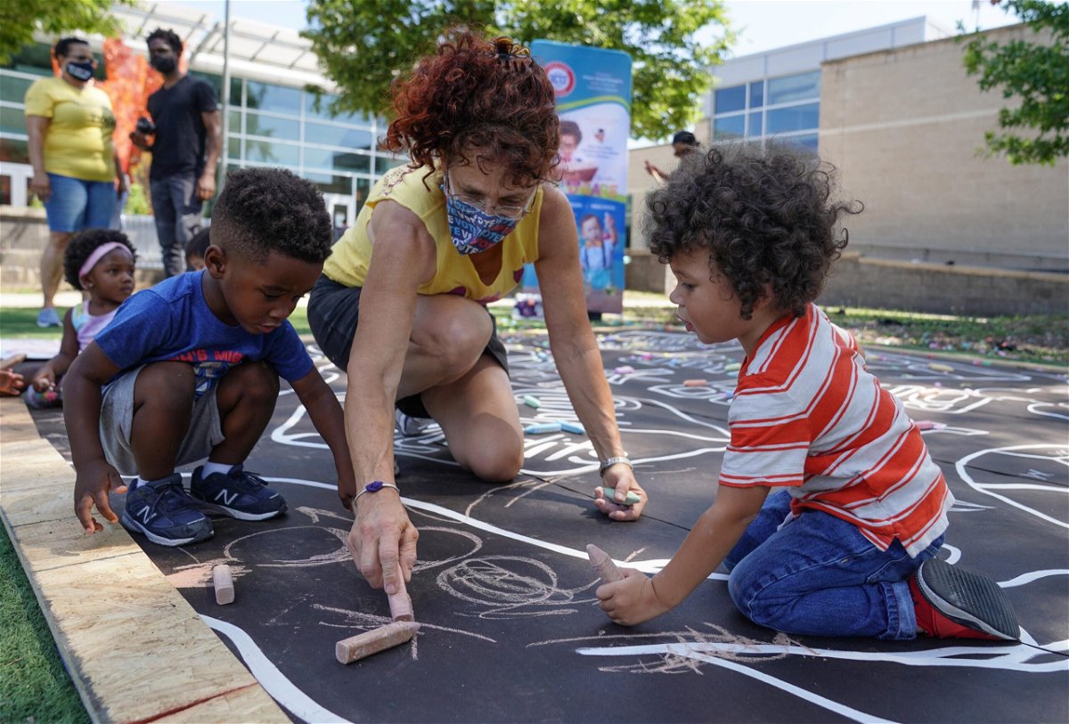 <i>Jemal Countess/Getty Images for Community Change</i><br/>Children from a childcare center complete a mural celebrating the launch of the Child Tax Credit on July 14