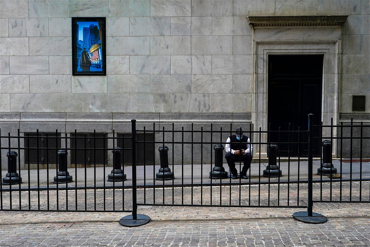 <i>Mary Altaffer/AP</i><br/>A stock broker takes a break outside the New York Stock Exchange