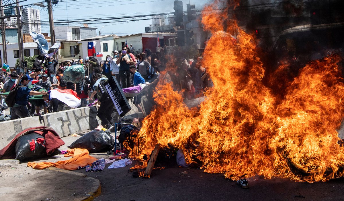 <i>Martin Bernett/AFP/Getty Images</i><br/>Restrictions on the movement of migrants are gaining momentum. Demonstrators burn a makeshift camp for Venezuelan migrants during a protest against illegal migration in Iquique