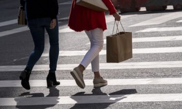 US price surges eased in the third quarter of the year. A pedestrian carries a shopping bag in San Francisco
