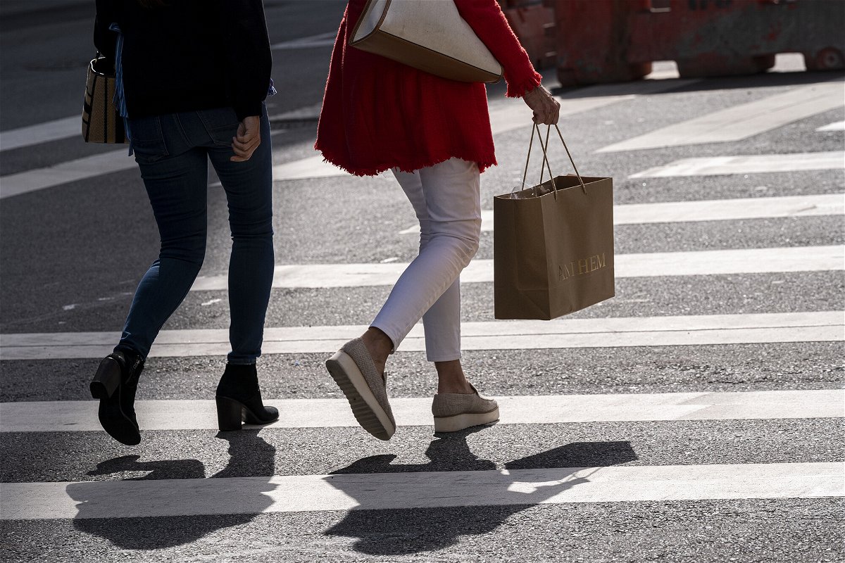 US price surges eased in the third quarter of the year. A pedestrian carries a shopping bag in San Francisco