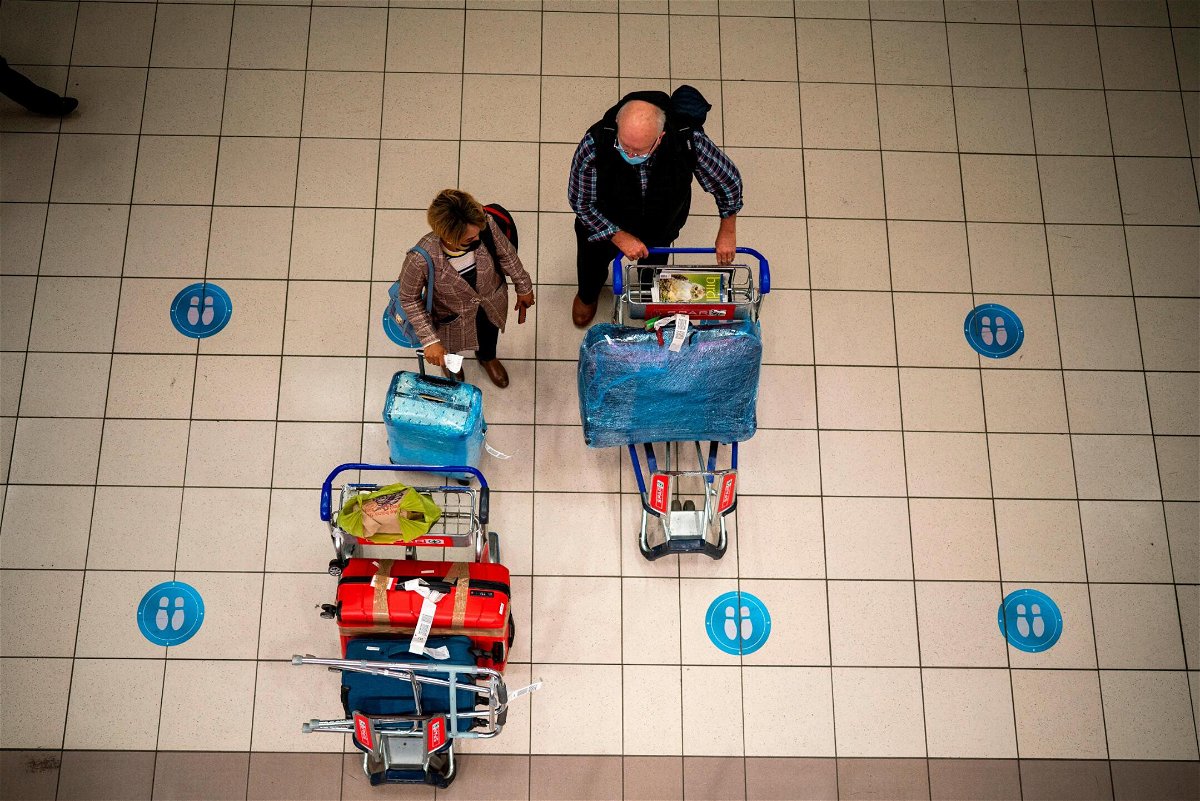 <i>Jerome Delay/AP</i><br/>People wait at OR Tambo's airport in Johannesburg