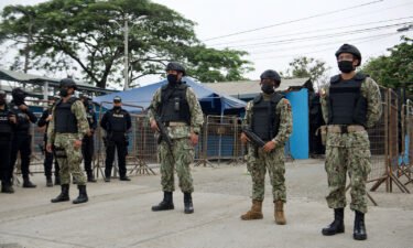 Military police stand guard outside the Guayas 1 prison after a violent outburst between the inmates that left 58 dead in Guayaquil