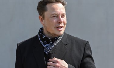 Elon Musk says he'll let Twitter users decide if he should sell 10% of the 170.5 million shares he holds in Tesla. Musk is shown here at a press event on the grounds of the Tesla Gigafactory.