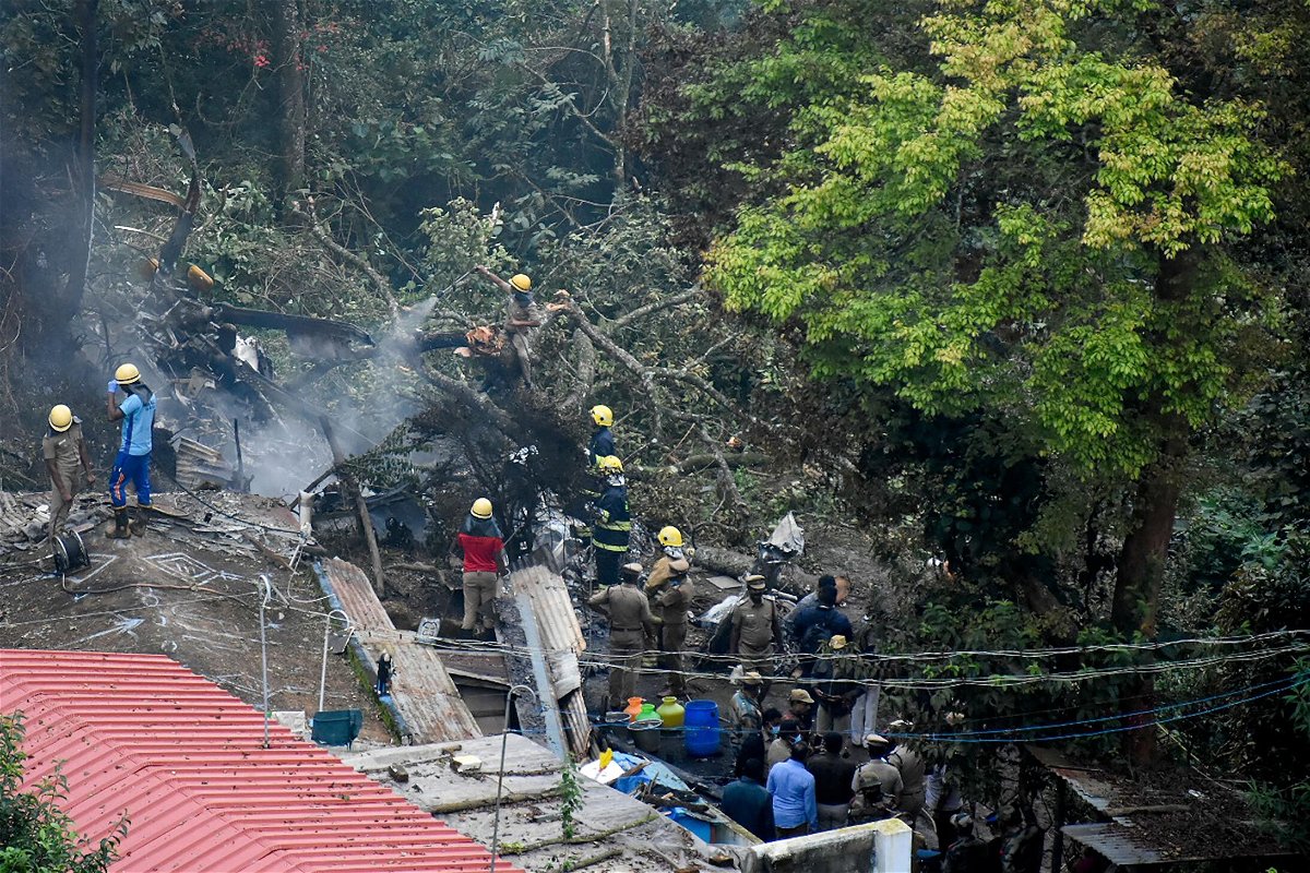 <i>Surya Narayanan/AFP/Getty Images</i><br/>Firemen and rescue workers try to control the fire in the burning debris of an IAF Mi-17V5 helicopter crash site in Coonoor