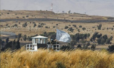 A UN peacekeeper stands on duty at an outpost of the United Nations Disengagement Observer Force (UNDOF) buffer zone between Syria and the Israeli-annexed Golan Heights on August 11