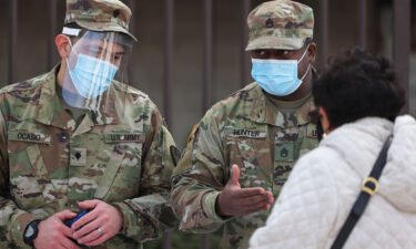 National Guard soldiers help people sign up for their vaccination appointments on February 24