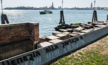 A female tourist was thrown out of Venice after she was caught posing for photos topless on a war memorial.
