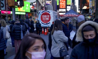 People wait in a long line to get tested for Covid-19 in Times Square