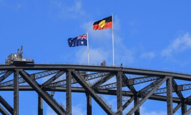 The Australian national flag flies alongside the Aboriginal flag atop the Sydney Harbour Bridge on May 26