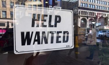 A 'help wanted' sign is posted in front of restaurant on February 4
