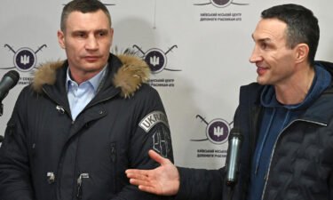 Kyiv mayor Vitali Klitschko (L) and his brother and former Ukrainian boxer Wladimir Klitschko (R) speak at a recruitment center in Kyiv in early February.