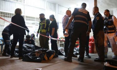 Israeli police and paramedics gather near bodies of people killed by a gunman in Bnei Brak