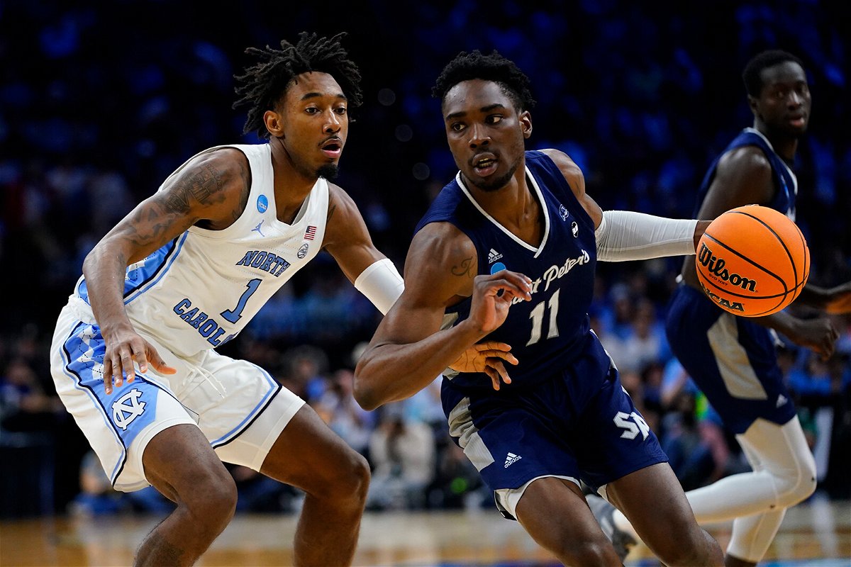 <i>Chris Szagola/AP</i><br/>St. Peter's KC Ndefo tries to get around North Carolina's Leaky Black during the first half of a college basketball game in the Elite 8 round of the NCAA tournament.