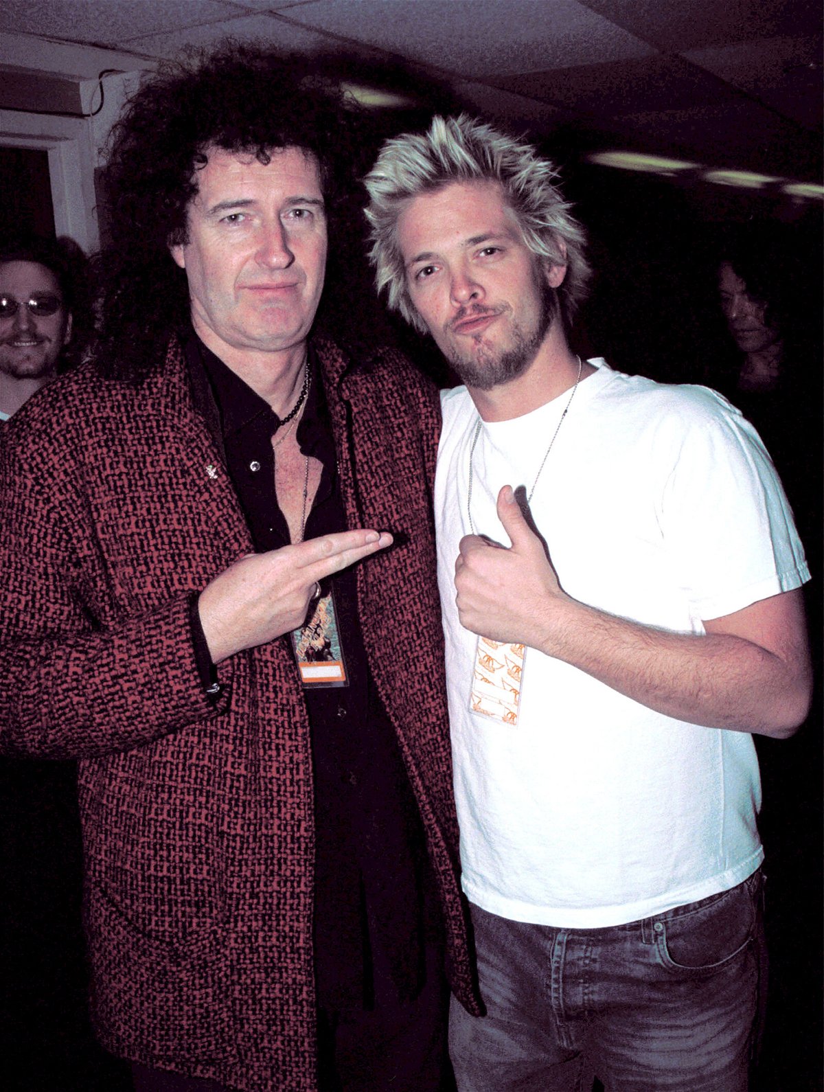 <i>David Klein/Getty Images</i><br/>Queen guitarist Brian May (L) poses with Taylor Hawkins in January 2002. Taylor Hawkins became a drummer after being wowed by Queen drummer Roger Taylor.