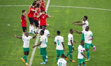 Senegal's players celebrate during a penalty shootout against Egypt in Dakar